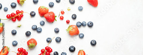 Various fresh berries on neutral background.