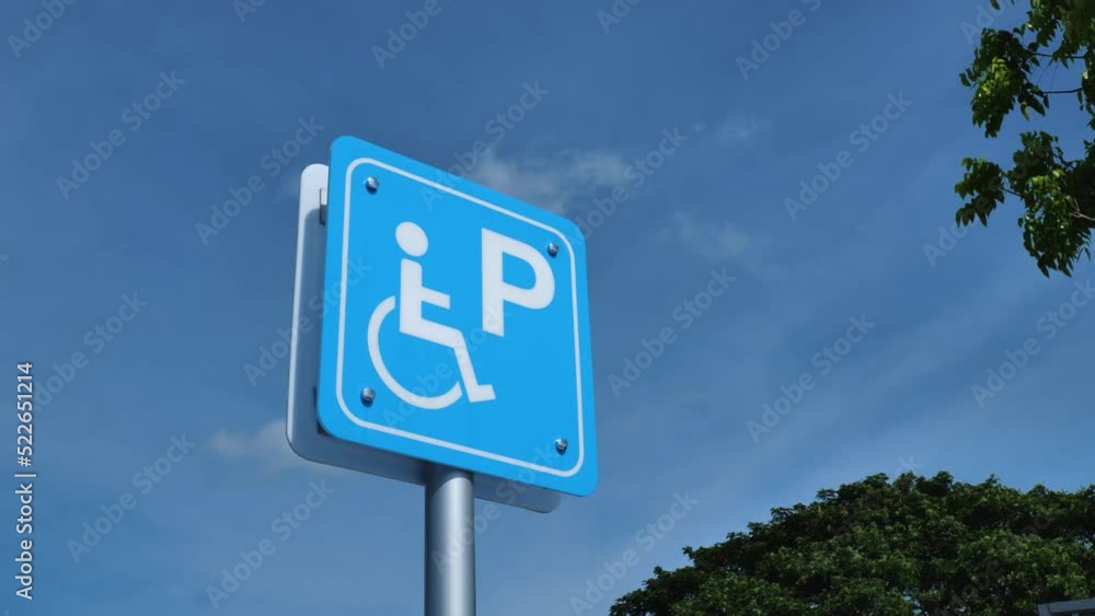 The handicap sign is outside the building. The handicap sign is outside the building.