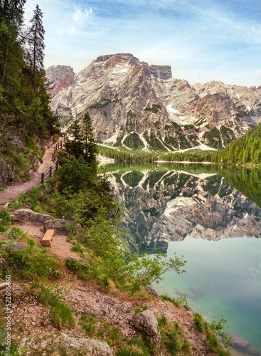 View from lakeside hiking trail to Mount Seekofel mirroring in the clear water of iconic natural mountain lake Pragser Wildsee (Lago di Braies) in Dolomites, Unesco World Heritage, South Tyrol, Italy photo