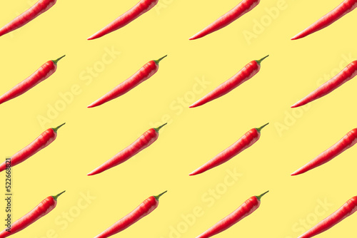 Red hot chili peppers on yellow background. Seamless repeating pattern.
