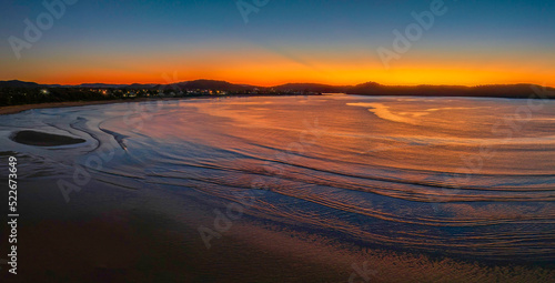 Aerial sunrise seascape with orange glow on a cold Winter s morning