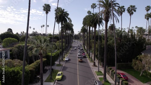 Aerial Forward Shot Of Vehicles Moving On Road Amidst Palm Trees -  Beverly Hills, California