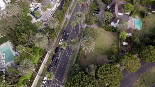 Aerial Forward Shot Of Cars Moving On Road Amidst Houses In City -  Beverly Hills, California