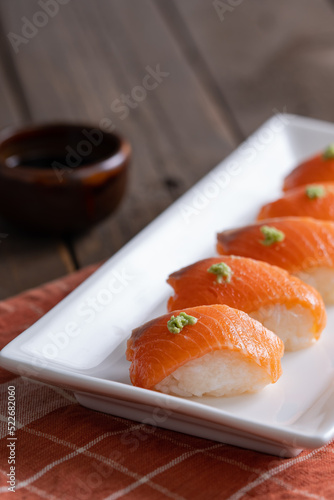 delicious fresh sashimi nigiri with wasabi on top and Japanese soy sauce on the side
