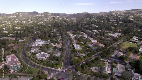 Aerial Beautiful Shot Of City On Green Landscape, Drone Flying Forward Over Cars Moving On Roads -  Beverly Hills, California