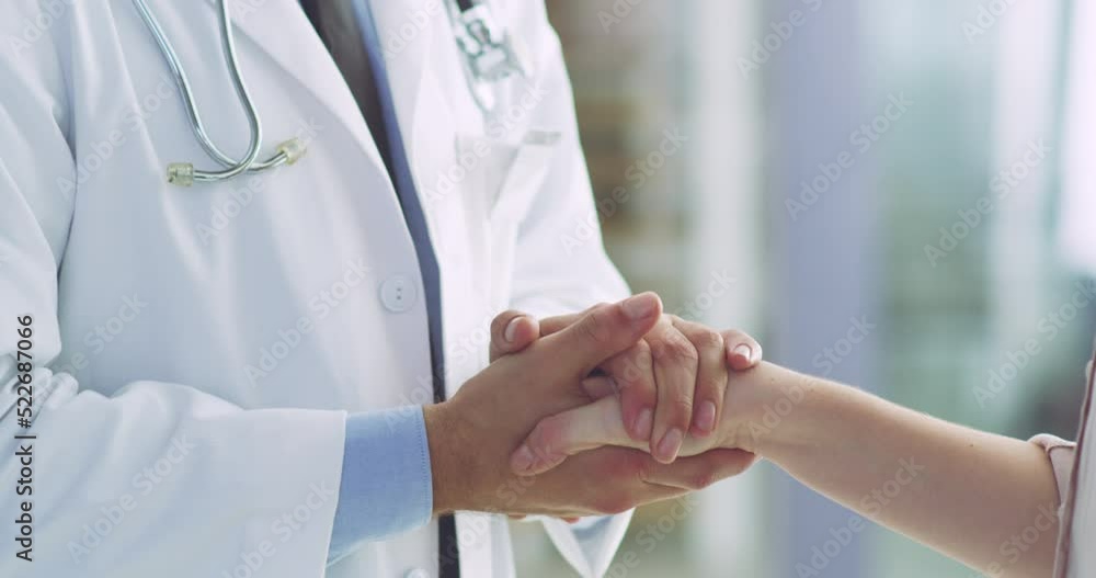 Healthcare, support and trust while doctor holds hand of a patient while talking in a hospital. Medical professional sharing bad news during consultation while comforting a woman sick with cancer Healthcare, support and trust while doctor holds hand of a patient while talking in a hospital. Medical professional sharing bad news during consultation while comforting a woman sick with cancer