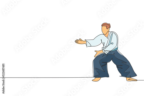 One continuous line drawing of young man aikido fighter practice fighting stance pose at dojo training center. Martial art combative sport concept. Dynamic single line draw design vector illustration