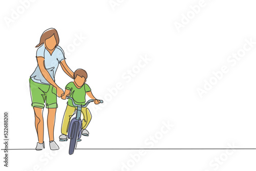 Single continuous line drawing of young kids boy learning ride bicycle with mother at outdoor park. Parenthood lesson. Family time concept. Trendy one line draw graphic design vector illustration