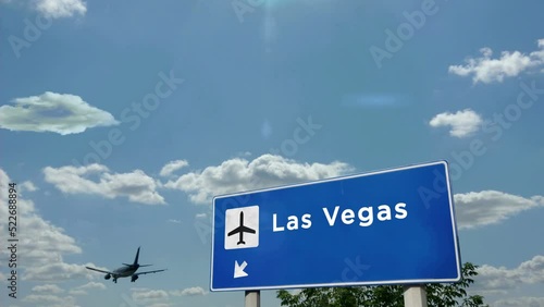 Jet plane landing in Las Vegas, Nevada, USA. City arrival with airport direction sign. Travel, business, tourism and airplane transport concept.