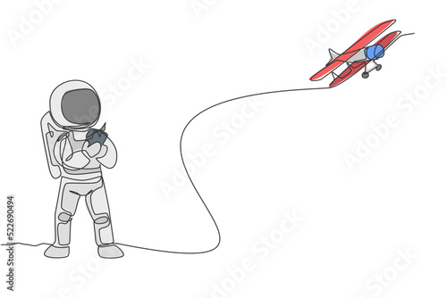 One single line drawing of astronaut playing airplane radio control in moon land graphic vector illustration. Doing hobby while leisure time in deep space concept. Modern continuous line draw design