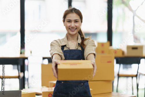 Attractive Asian SME business woman checking order at warehouse © itchaznong