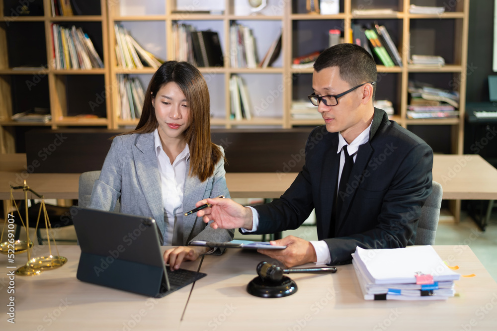 Fototapeta premium Asian business team and lawyers discussing contract papers sitting at the table. Concepts of law, advice, legal services. at office