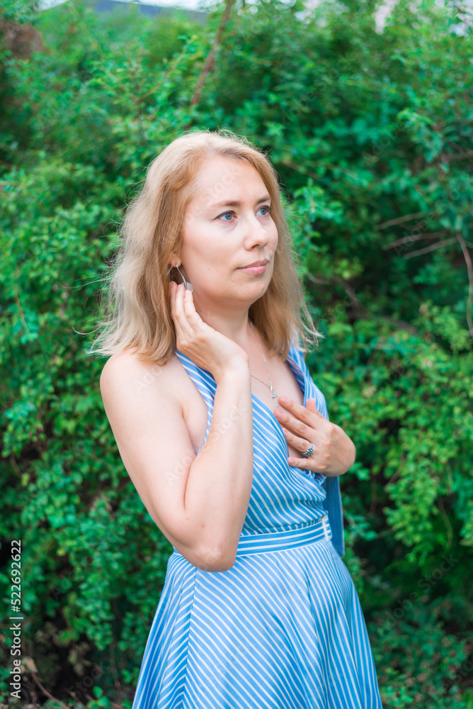 Fototapeta premium A young woman dreams in the park