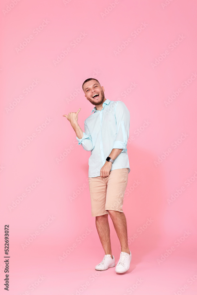cheerful young happy man dance on pink background. cheerful young happy man dance on pink background.