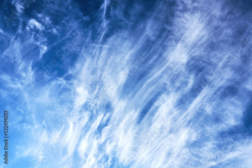 Cirrus clouds on a sunny summer day. Blue, blue sky with rugged, cirrus clouds. Natural manifestations