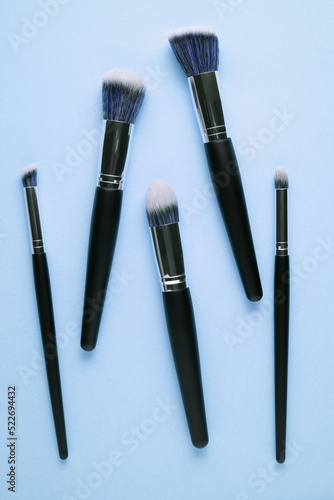 Creative concept beauty fashion photo of cosmetic product make up brushes kit on pink background.
