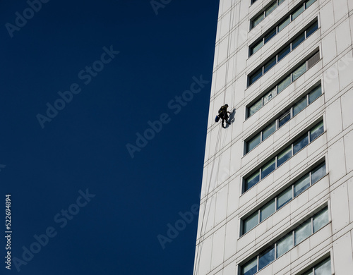 Industrial climber in helmet and uniform on height