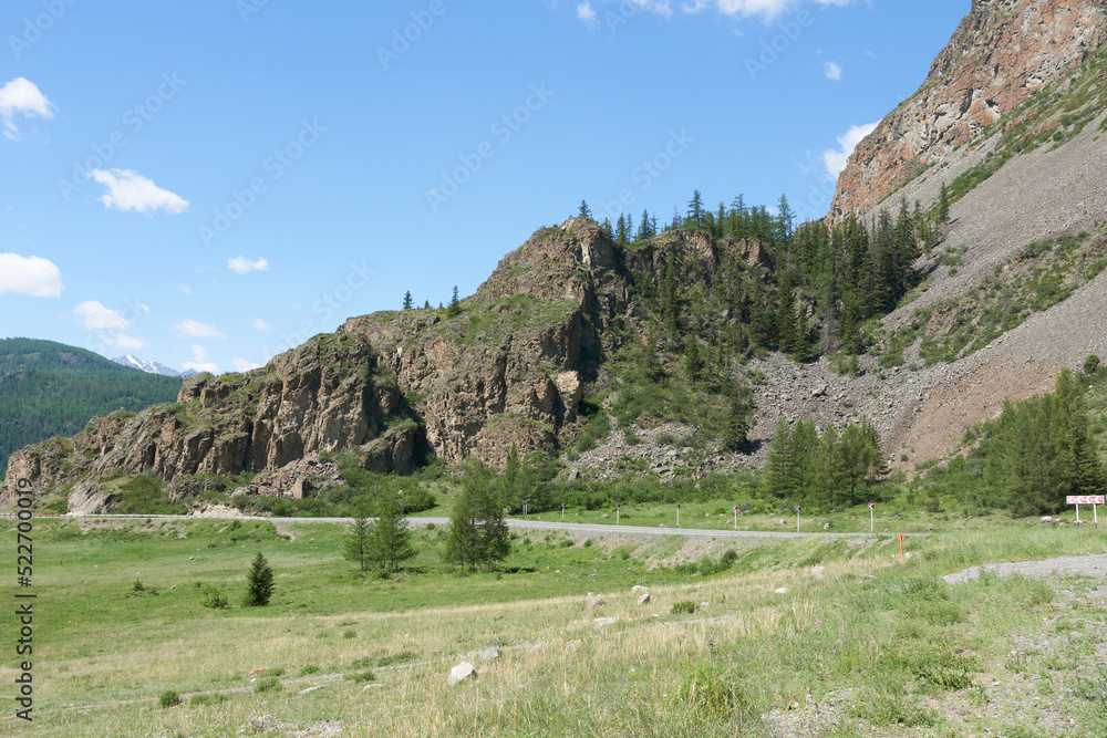 The road along the mountain ridge. The Altai Mountains in summer.
