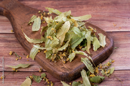 Leaves of linden tea. Dried linden tea on wood floor. Herbal tea concept. Healthy drinks. close up
