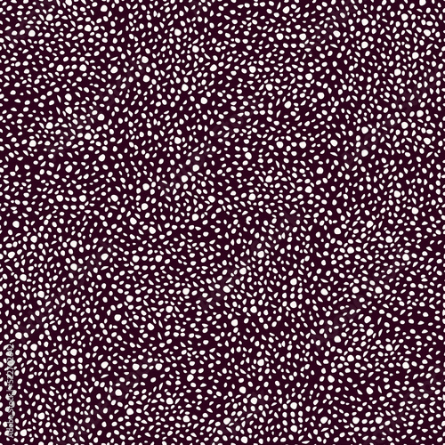 Abstract vector seamless pattern of white dots on dark background.