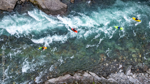 Group of friends spending time on the river enjoying kayaking and rafting together