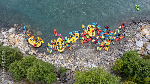 Group of friends spending time on the river enjoying kayaking and rafting together photo