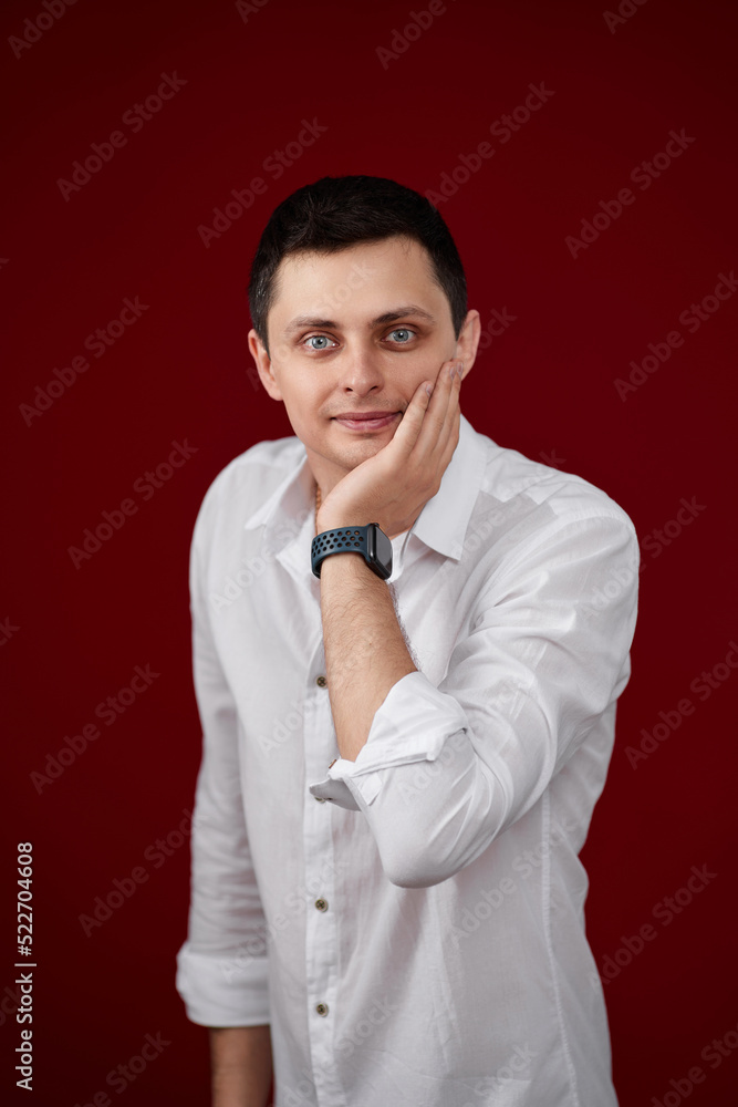man holding arms folded, touching chin with hand man holding arms folded, touching chin with hand