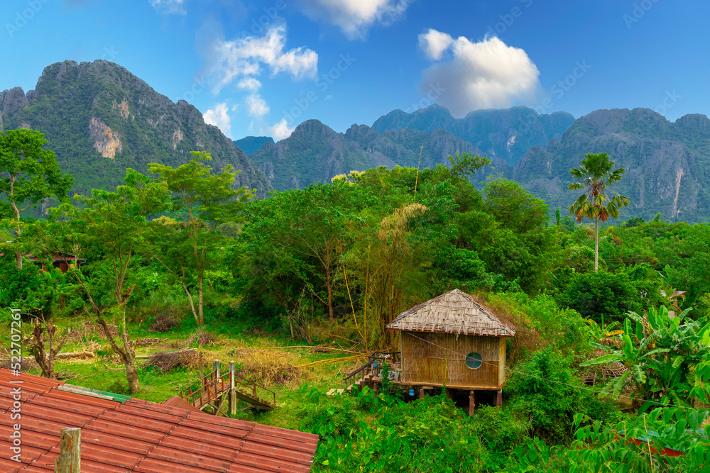 Vang Vieng Laos a beautiful city on the river with huge rising mountains and slow flowing river. 