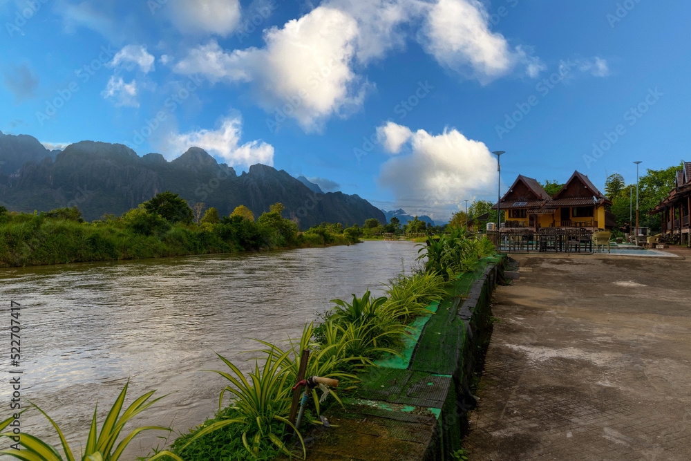 Vang Vieng Laos a beautiful city on the river with huge rising mountains and slow flowing river. Vang Vieng Laos a beautiful city on the river with huge rising mountains and slow flowing river.