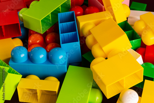 Multicolored plastic building blocks of the designer. Background of bright plastic building blocks.