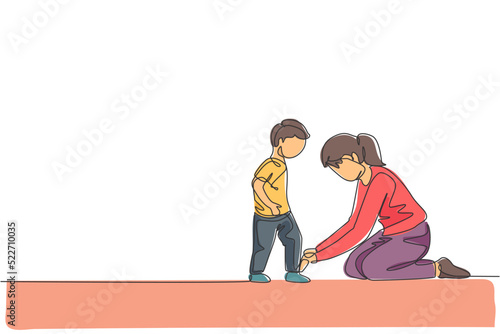 One continuous line drawing young happy mom at home tying her son shoelaces before going to school in the morning. Family parenting concept. Dynamic single line draw design vector illustration graphic