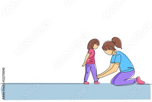 Single continuous line drawing of young mother tying her daughter shoelaces at home before go to school, parenthood. Family parenting concept. Trendy one line draw design vector graphic illustration