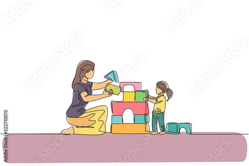 Single continuous line drawing of young mother playing with daughter building house from foam puzzle blocks toy at home, parenthood. Family parenting concept. One line draw design vector illustration