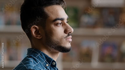 Fotografie Portrait of young serious arabic model man with beard in plaid shirt standing in