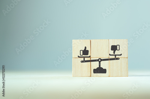 Accepted and rejected concept. Like and dislike on weight scales icon on wooden cubes with smart background. Thumb up and thumb down icon.