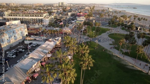 Aerial Forward Shot Of People Exploring Park By Beach In City -  Venice, Florida photo