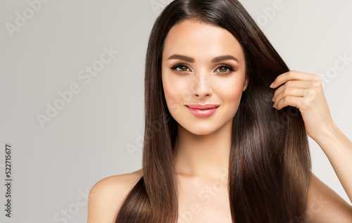 Beautiful model girl with shiny brown and straight long  hair . Keratin  straightening . Treatment, care and spa procedures. Smooth hairstyle
