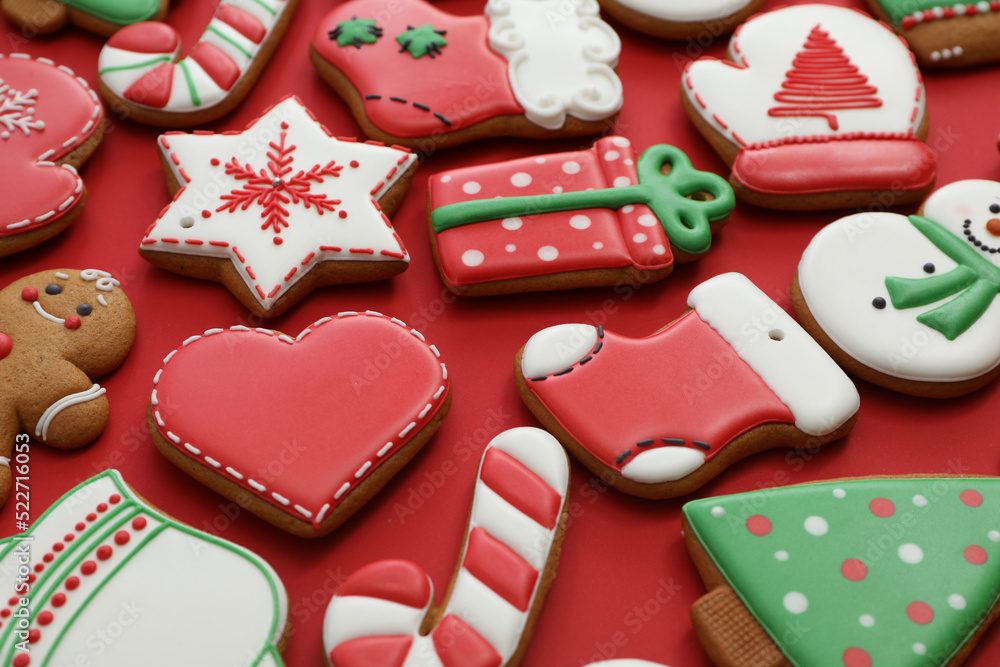 Different Christmas gingerbread cookies on red background, closeup