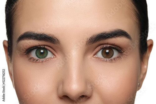 Woman with beautiful eyes of different colors, closeup. Heterochromia iridis