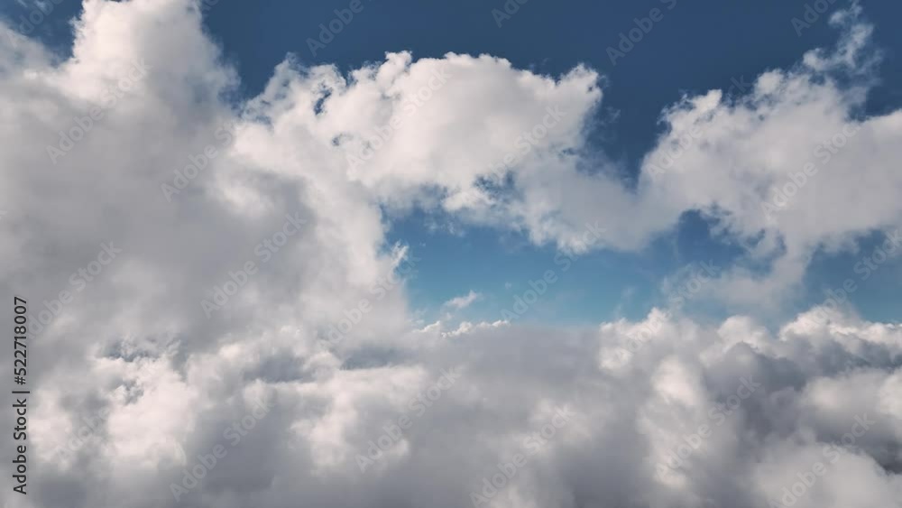 Aerial view Flying through beautiful thick fluffy clouds. Amazing timelapse of flowing soft white clouds moving slowly across a clear blue sky in clear daylight. Aerial view Flying through beautiful thick fluffy clouds. Amazing timelapse of flowing soft white clouds moving slowly across a clear blue sky in clear daylight.