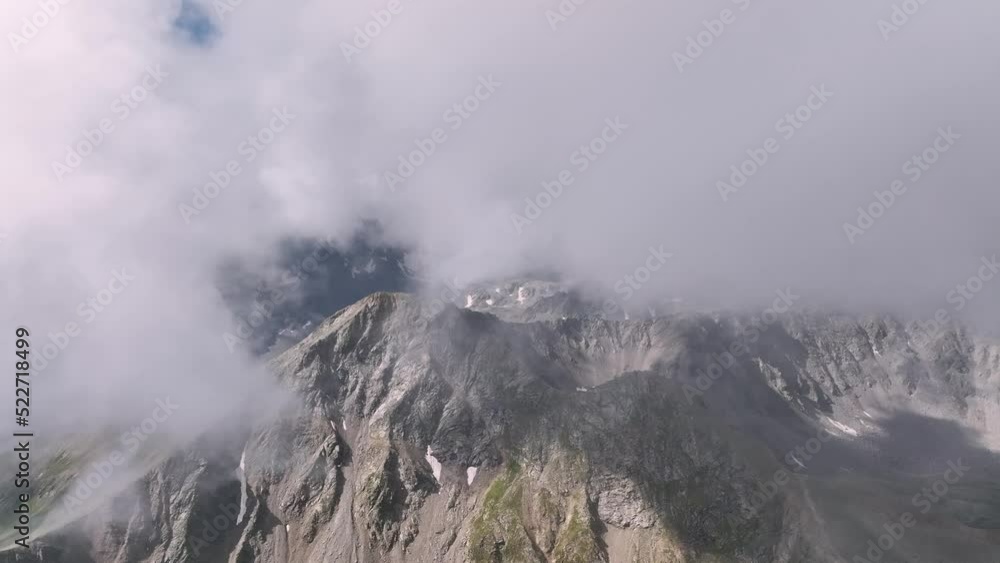 Cinematic aerial drone view of an unknown rocky mountain high in the mountains of the ridge in the caucasus. Cinematic aerial drone view of an unknown rocky mountain high in the mountains of the ridge in the caucasus.
