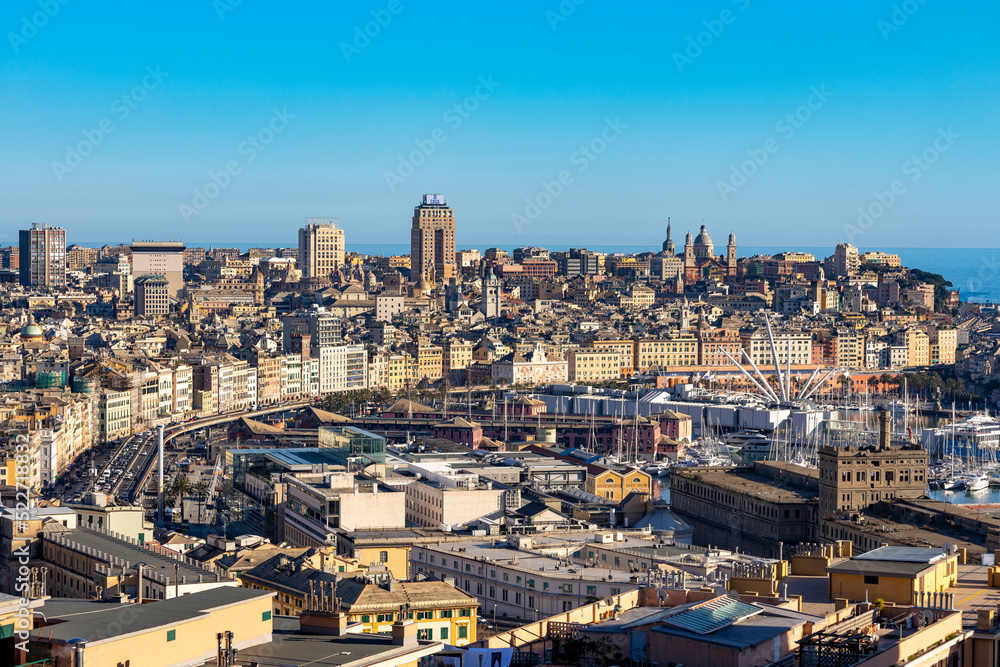 Panoramic view of Genoa in a sunny day with the causeway and the buidings of the historic center, Italy