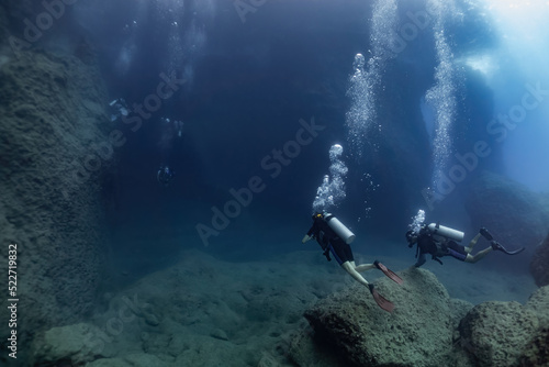 scuba divers in the cave.