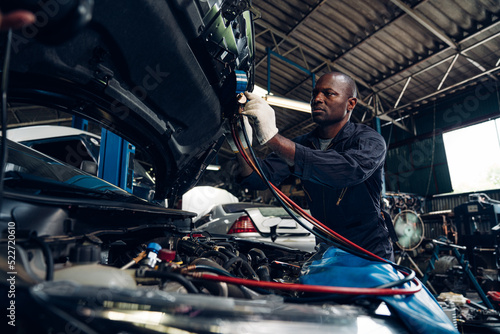 Auto mechanic are  repair and maintenance auto engine is problems at car repair shop. © kelvn