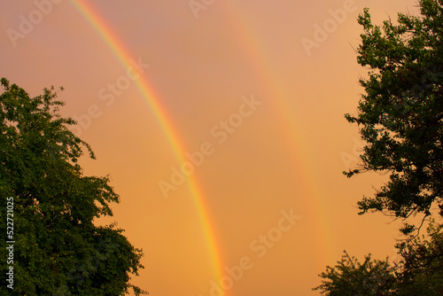 Sunset with two rainbows after a hurricane in the Kharkiv region of Ukraine in the summer of 2022