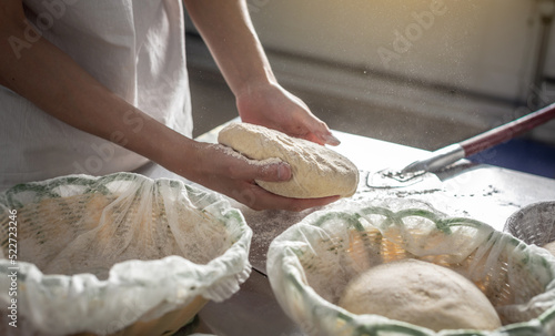 The baker is a man in the process of baking bread. Production of bakery products as a small business