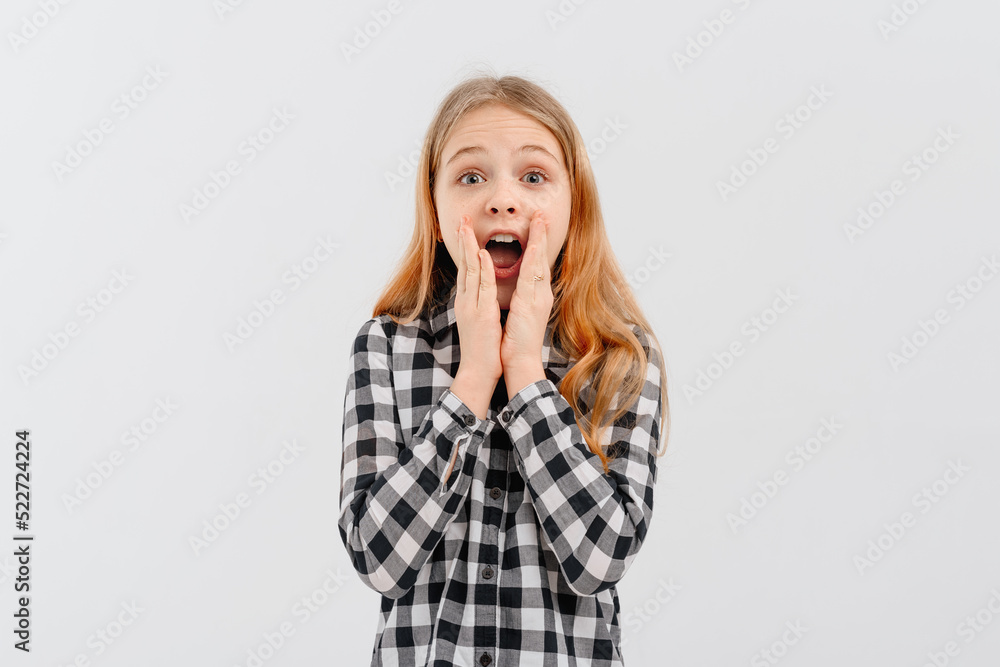 Amused teen girl hears wonderful news, raising hands joyfully, stare camera astonished, gasping open mouth wide in surprise, reacting amazed on promo, standing white background Amused teen girl hears wonderful news, raising hands joyfully, stare camera astonished, gasping open mouth wide in surprise, reacting amazed on promo, standing white background