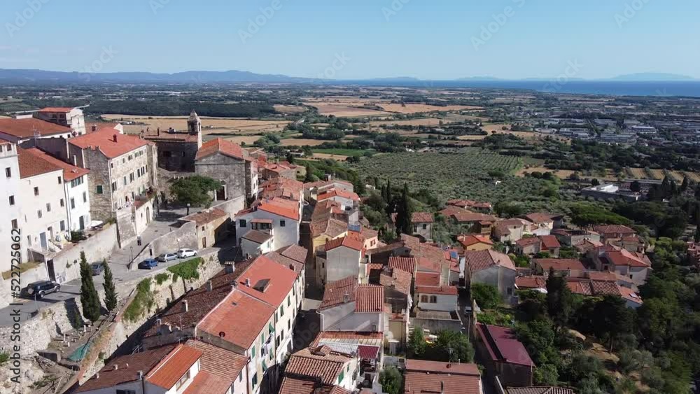 Rosignano Marittimo Maritime clock tower castle aerial panning left view. Summer season Rosignano Marittimo Maritime clock tower castle aerial panning left view. Summer season
