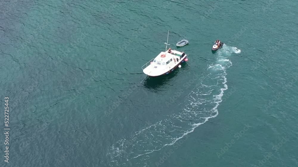 Aerial orbit shot of a jet ski and small boat on the Cornish coast, UK. Aerial orbit shot of a jet ski and small boat on the Cornish coast, UK.