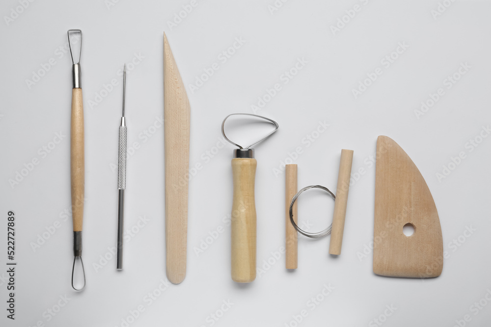 Set of clay modeling tools on white background, flat lay Set of clay modeling tools on white background, flat lay